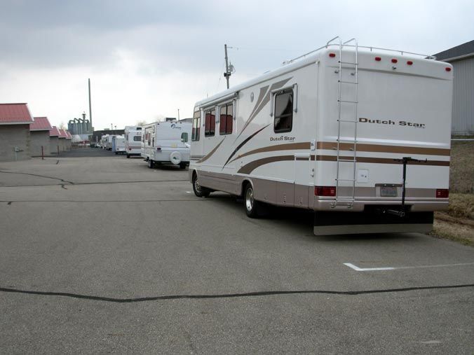 A row of rvs parked on the side of the road.