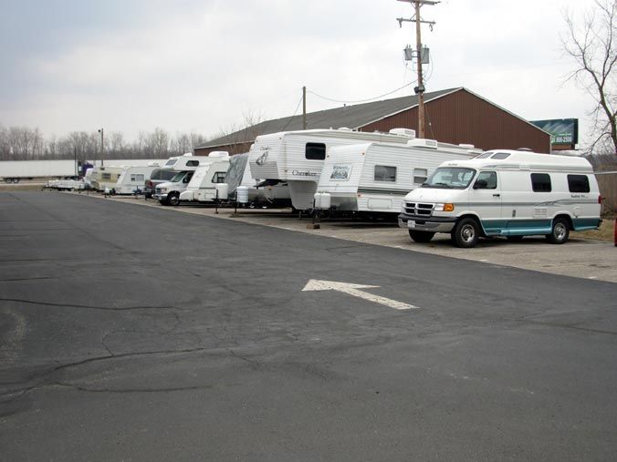 A row of rvs parked on the side of the road.