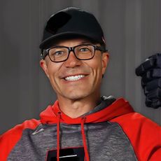Hockey player, Montreal Canadiens, holding up the Stanley Cup trophy, arms raised in celebration.