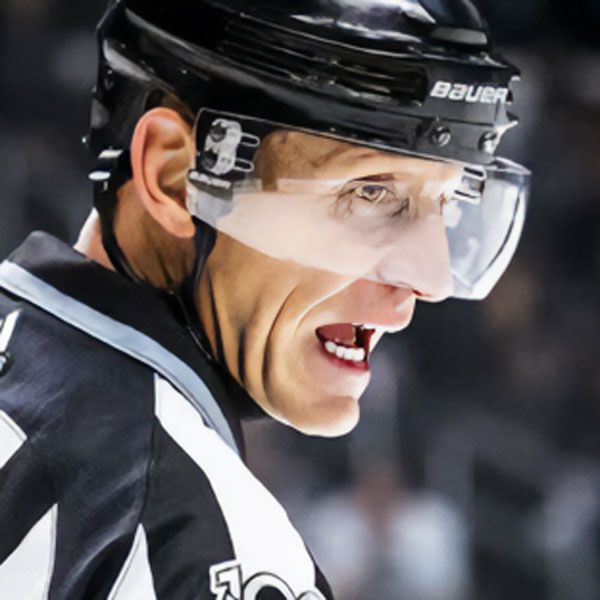 Hockey referee with visor, mouth open, looking to the side. Wearing black and white stripes.