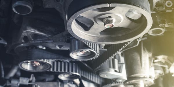 A close up of a belt on a car engine.