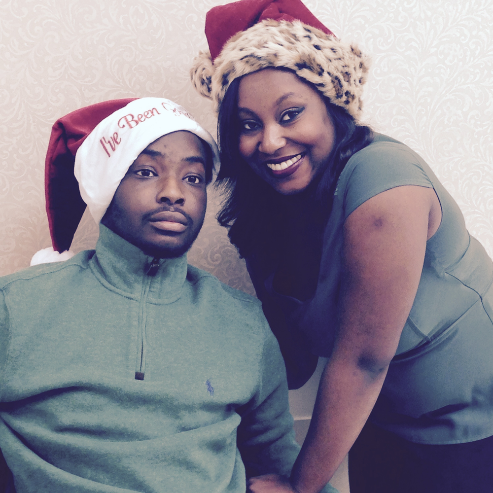 A man wearing a santa hat beside a woman