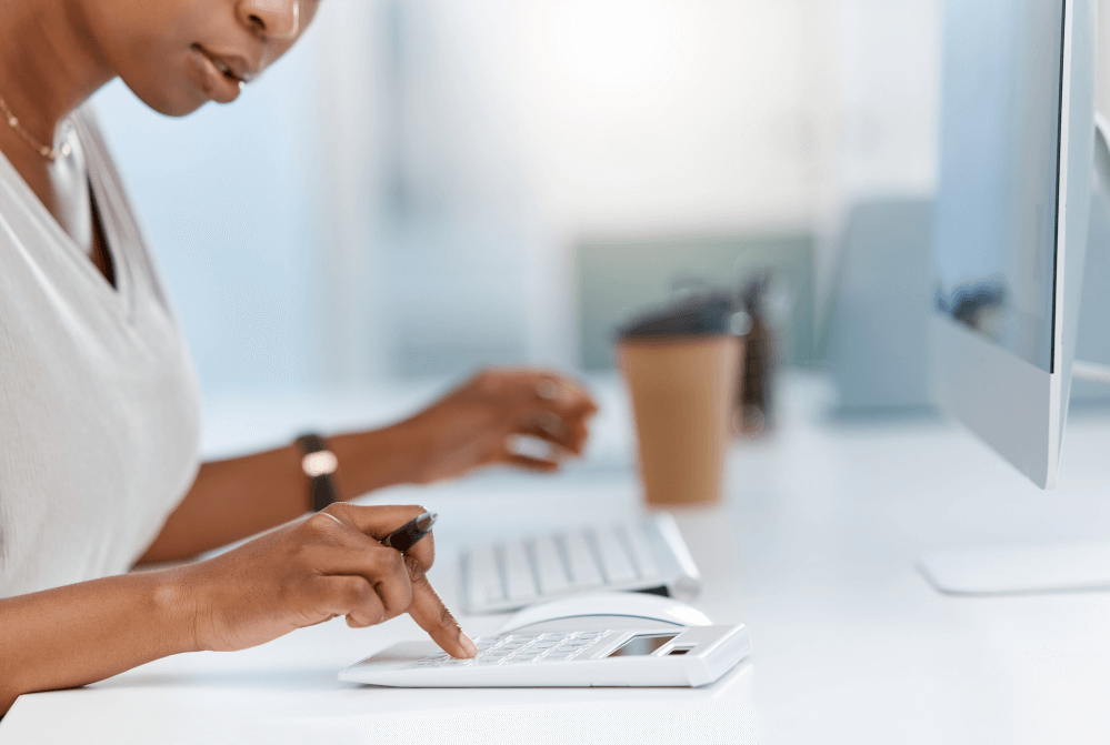 A woman is sitting at a desk using a computer.