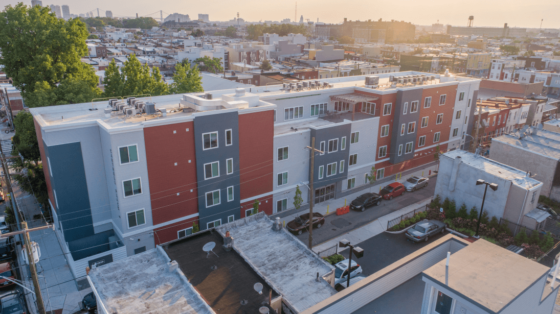 An aerial view of a large apartment building in a city.