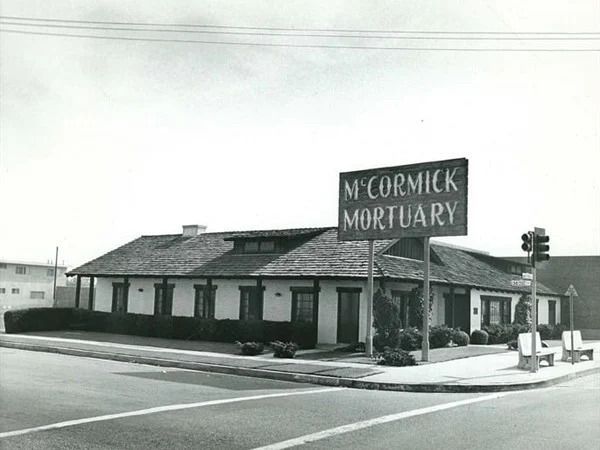 McCormick Mortuary building with large sign, corner view, daytime.