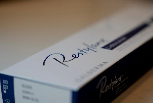 Box of Restylane dermal filler. White box with blue text and a partially visible label.