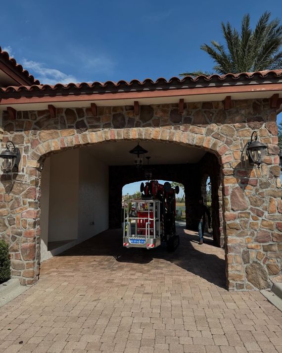 Stone archway with a colorful small train cart passing through a shaded passage outdoors Stone archway with a colorful small train cart passing through a shaded passage outdoors