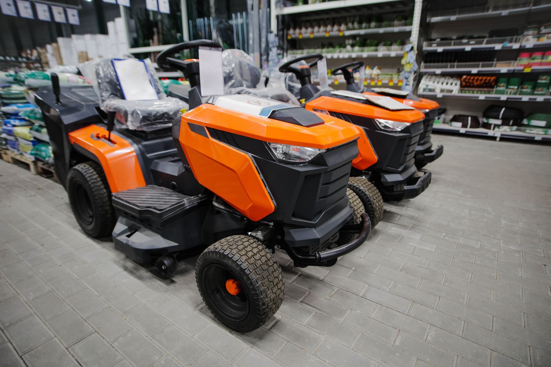 New ride-on lawn tractors for sale at a farm machinery centre New ride-on lawn tractors for sale at a farm machinery centre
