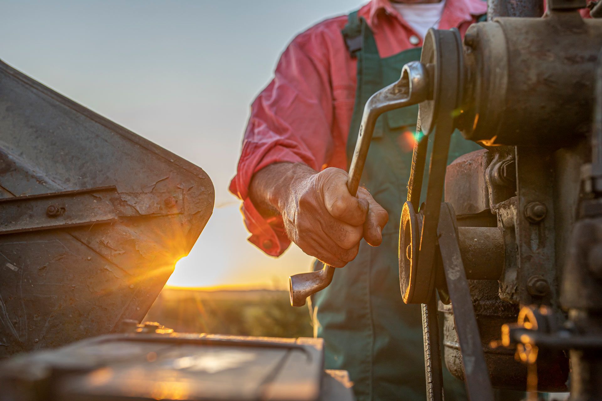 Man Repairing Engine with Sunset | Ararat, Vic | Ararat Auto & Ag Services