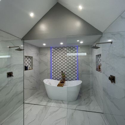 A bathroom with a bathtub and a walk in shower.