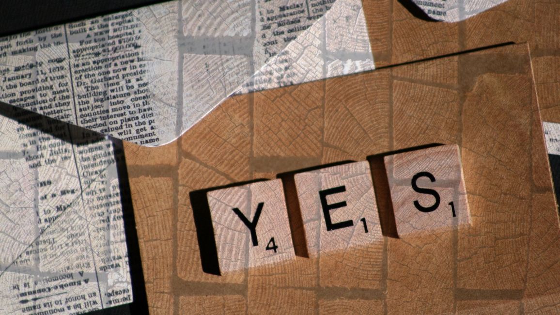 the word yes is written on a piece of cardboard