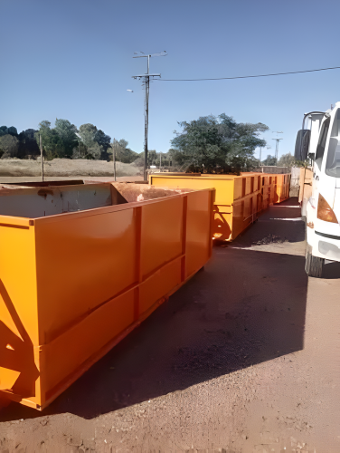 Red Dumpster Filled With Green Leaves and Branches — Mount Isa Skips In Cloncurry, QLD
