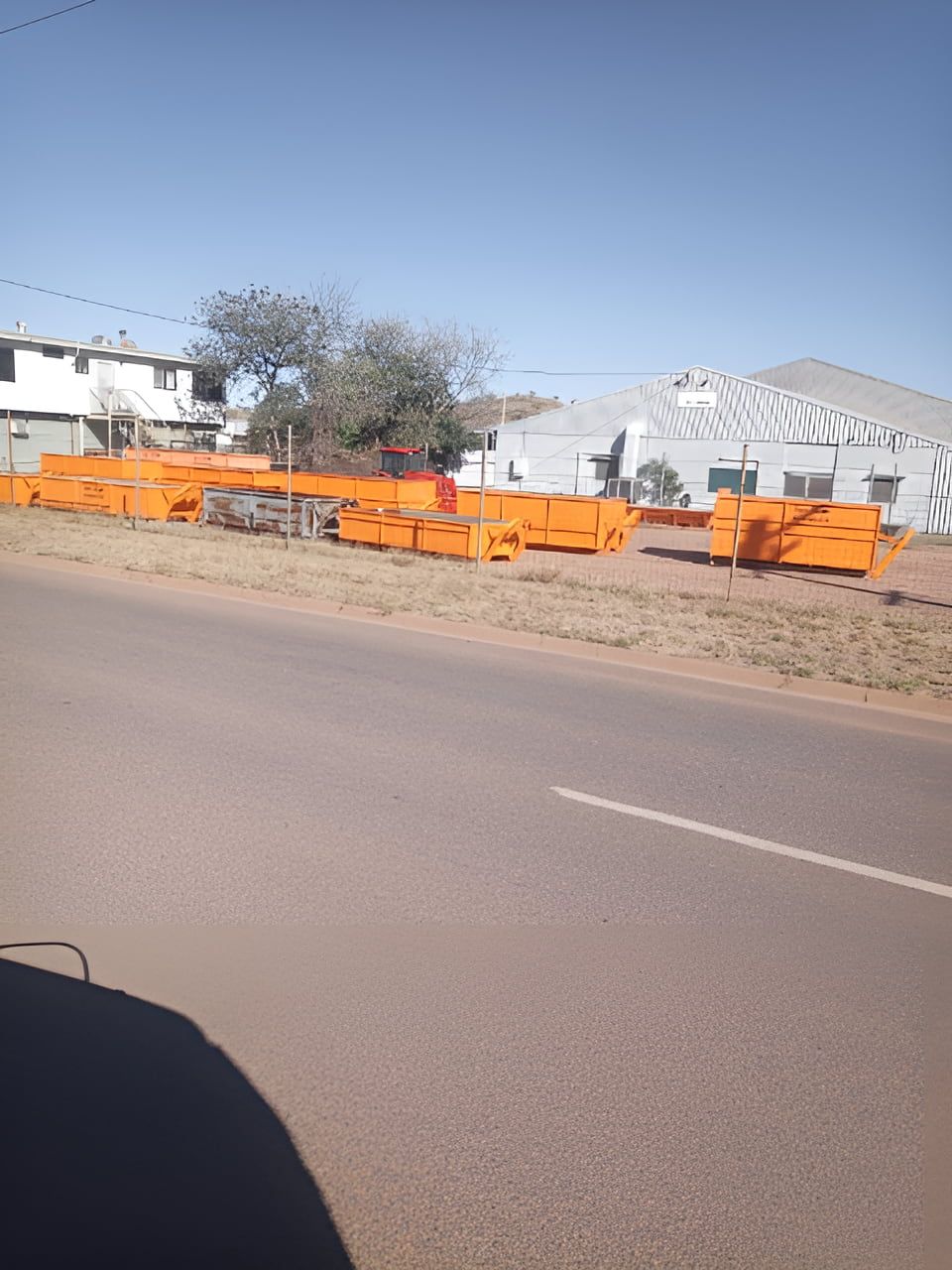 A Row Of Orange Dumpsters Are Parked On The Side — Mount Isa Skips In Mount Isa, QLD