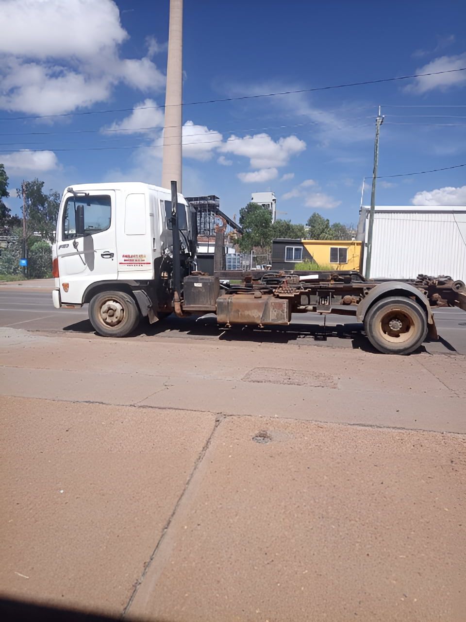 A White Truck With A Crane On The Back Is Parked On The Side — Mount Isa Skips In Mount Isa, QLD