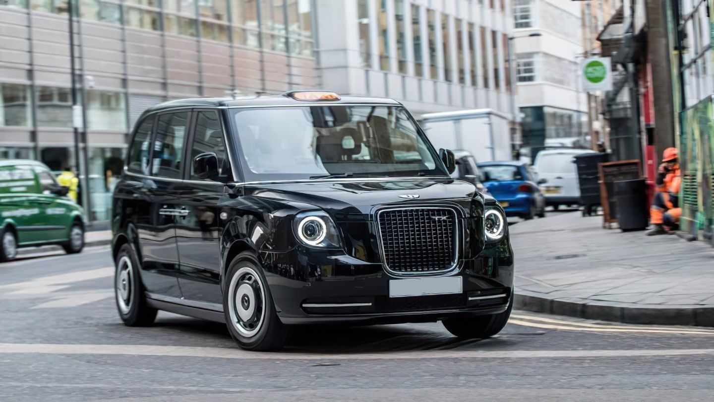 image of a black LEVC black cab turning a corner