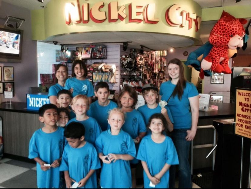 A group of children are posing for a picture in a gym.
