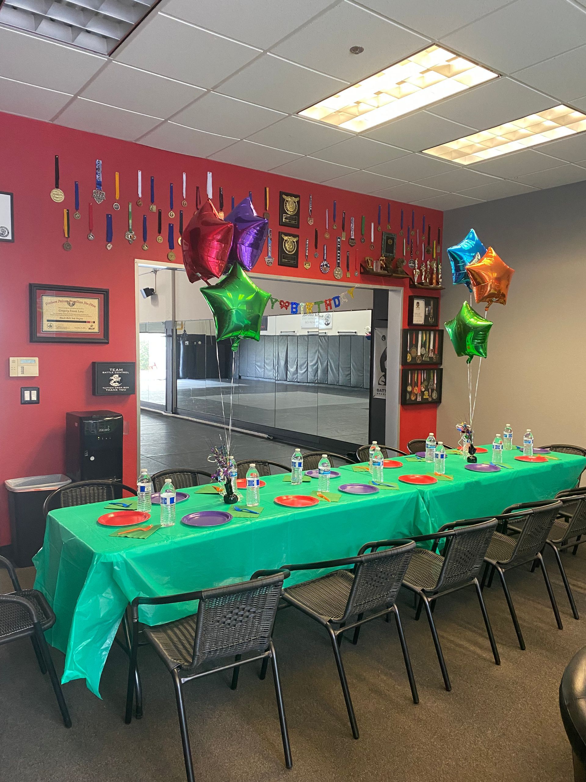 A long table with plates and balloons on it