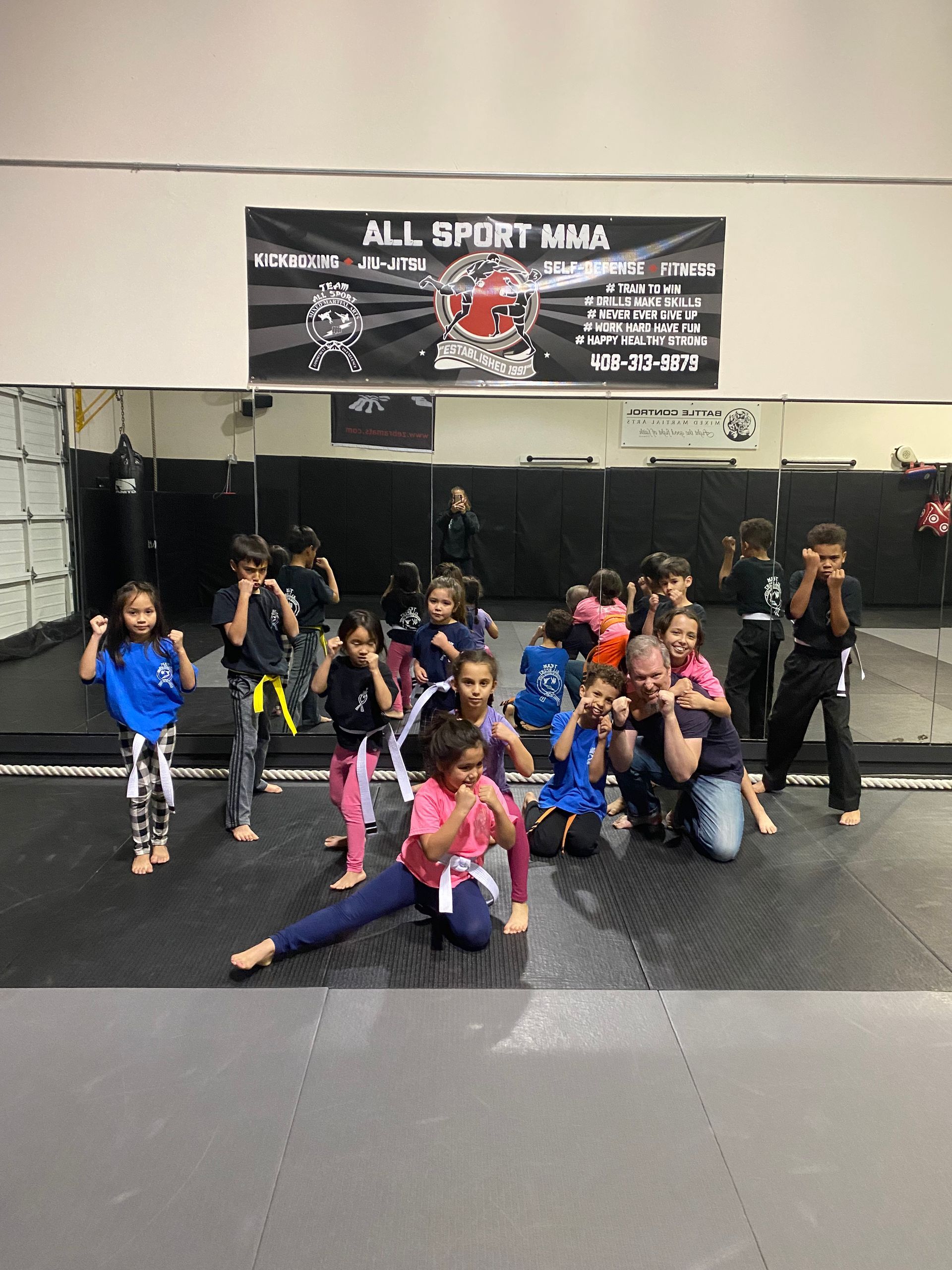 A group of children are posing for a picture in a gym.
