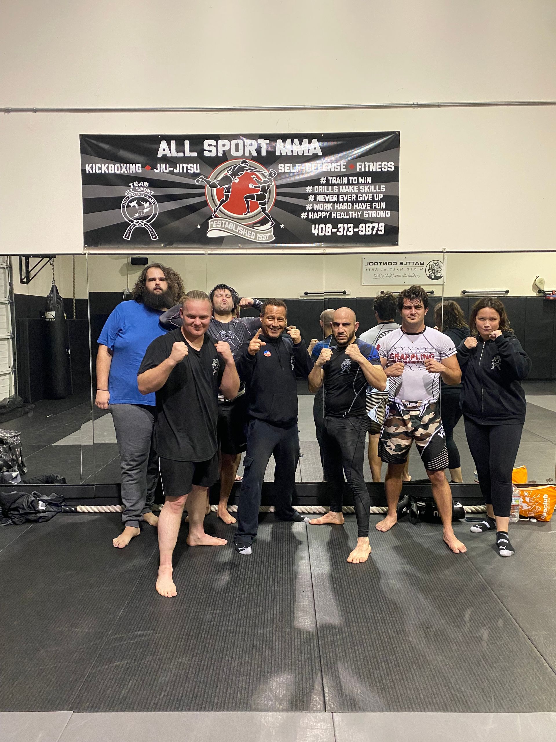 A group of children are posing for a picture in front of nickel city