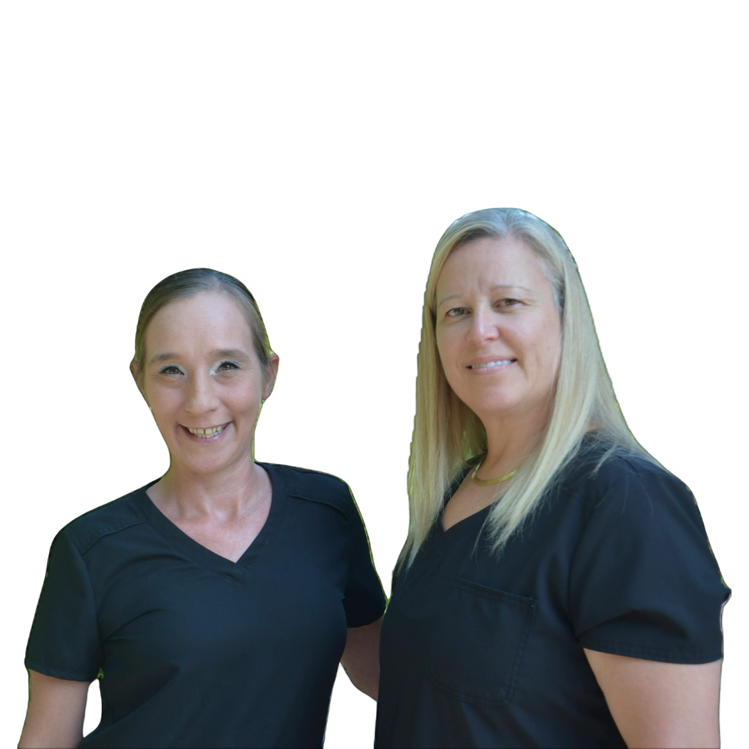 Two women are standing next to each other and smiling for the camera