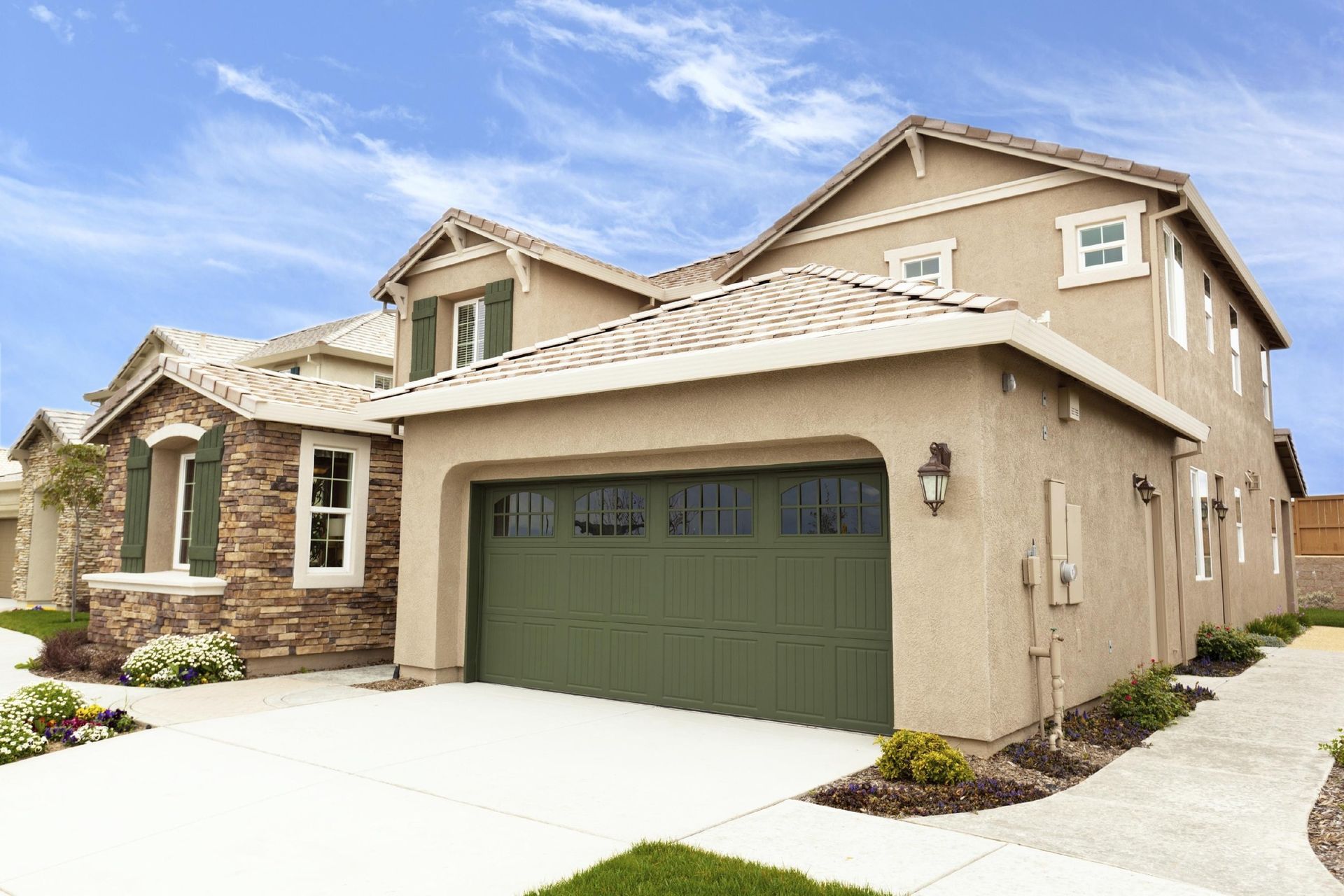 A large house with a green garage door