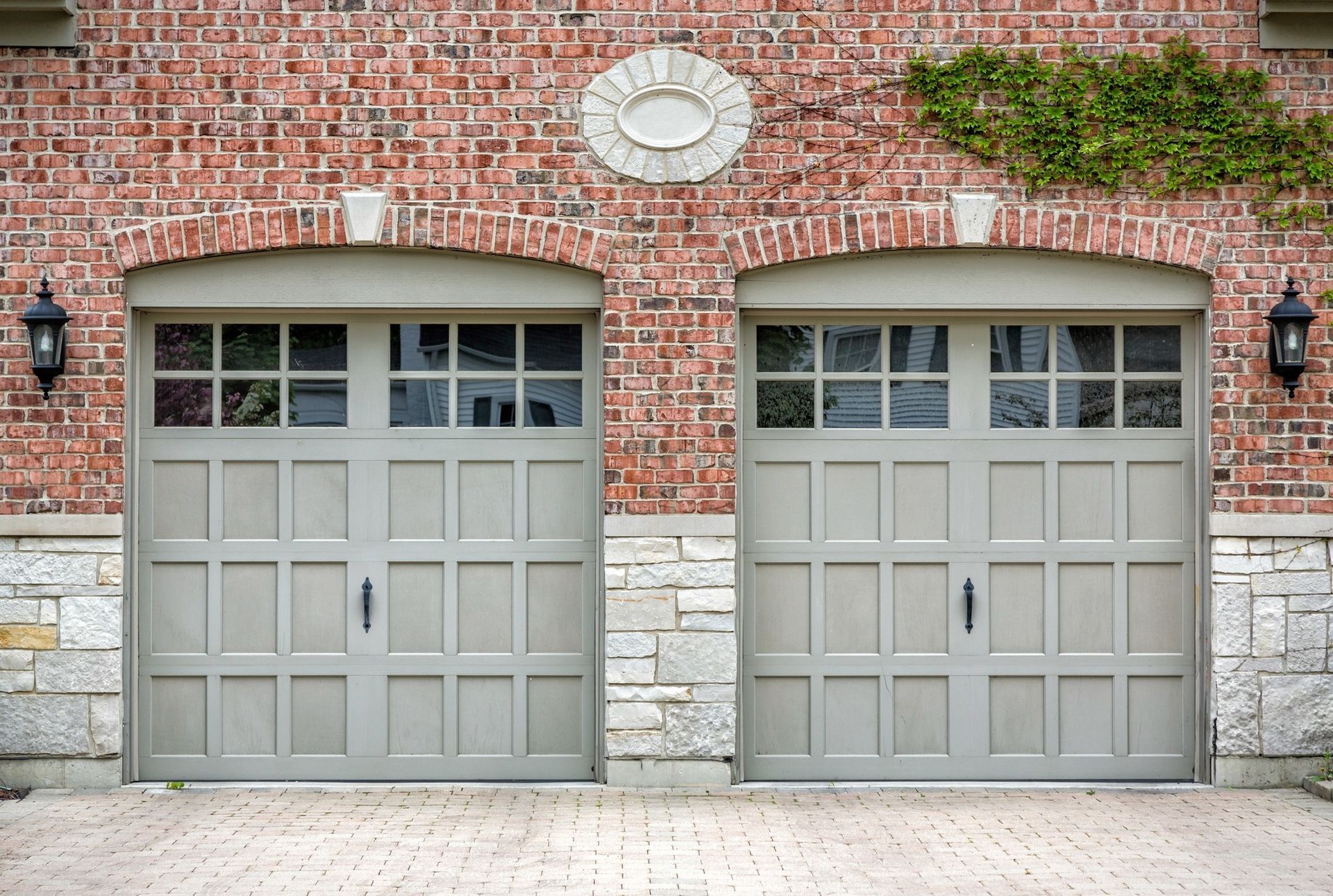 A pair of garage doors on a brick building
