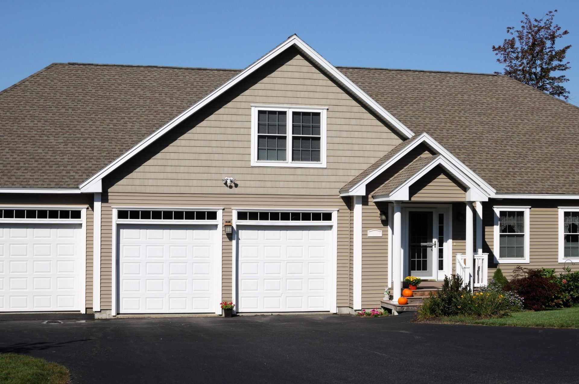 The front of a house with three garage doors