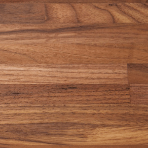 A close up of a wooden cutting board showing the grain and texture.