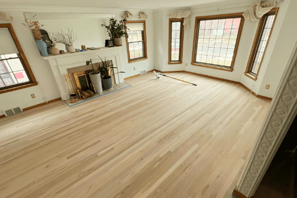 A living room with hardwood floors and a fireplace