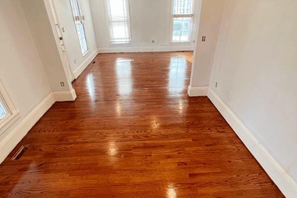 A living room with hardwood floors and white walls
