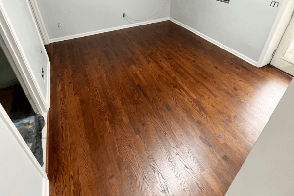 A room with hardwood floors and gray walls.