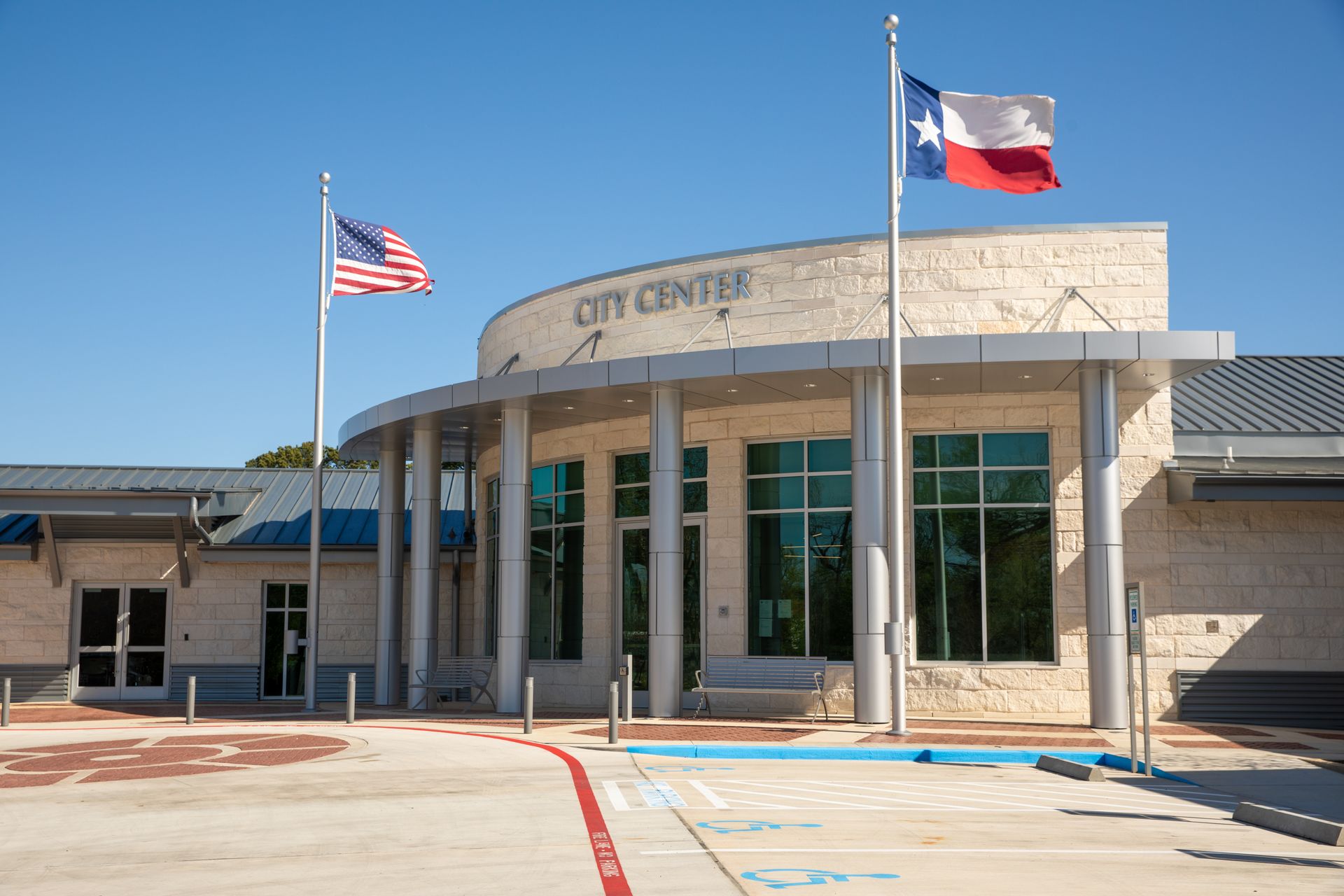 A counter in a restaurant with a display case and flowers on it
