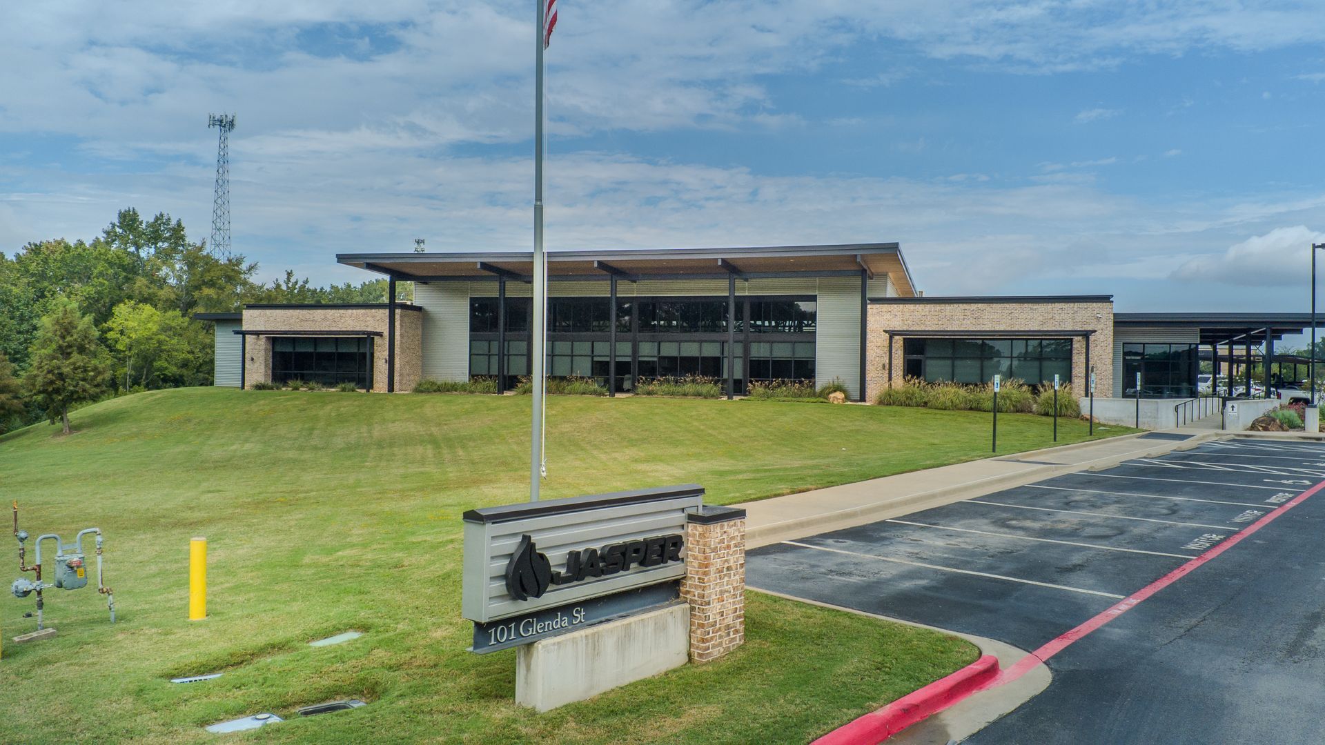 A living room with a couch , chairs , coffee table and lamps.