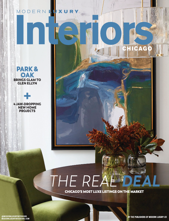 The cover of a modern luxury interiors magazine shows a dining room with a table and chairs.