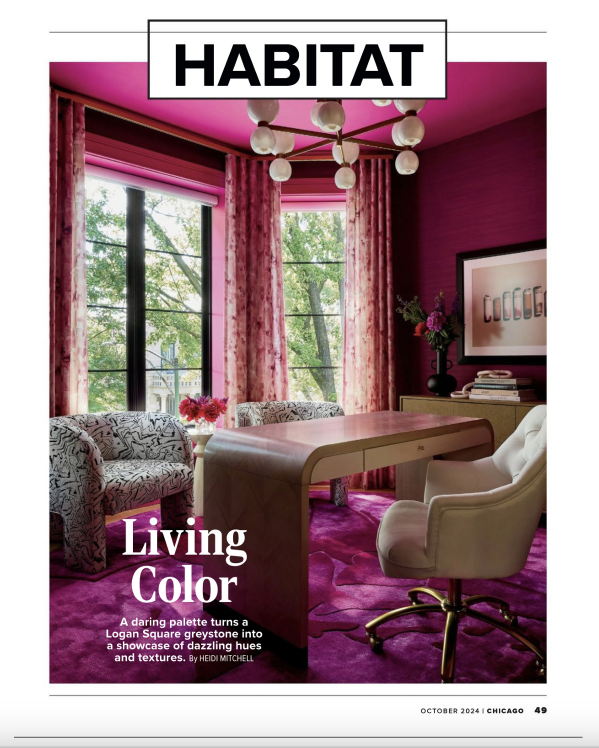 A living room with pink walls , curtains , a desk and chairs.