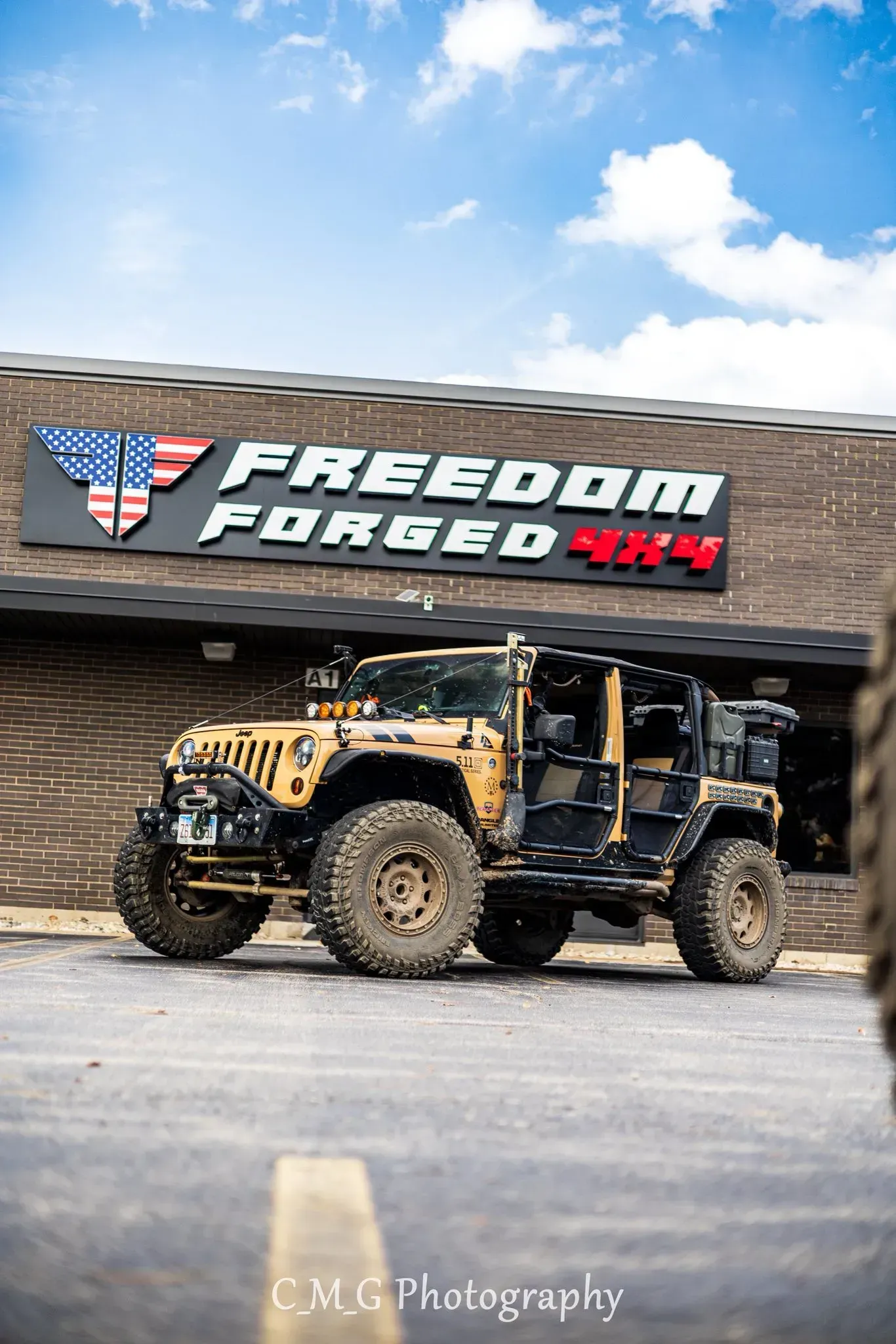 Tan Jeep Parked in Front of a Shop | Freedom Forged Auto Repair