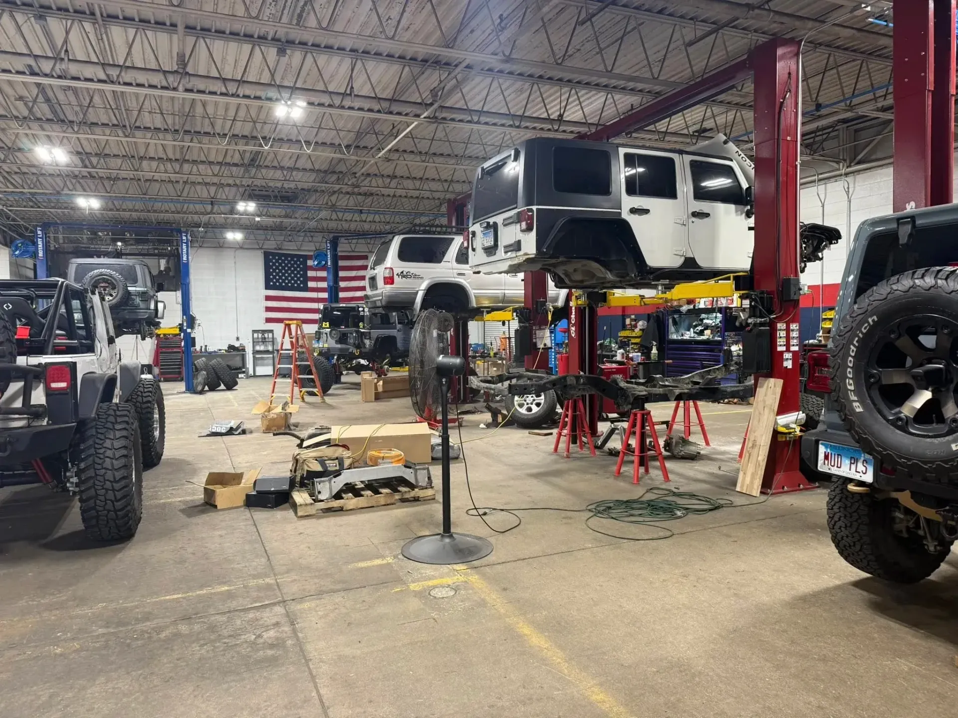 Auto Repair Shop with Several Jeeps on Lifts | Freedom Forged Auto Repair
