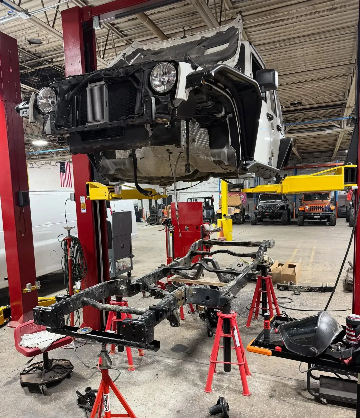 Jeep Being Repaired on a Lift | Freedom Forged Auto Repair