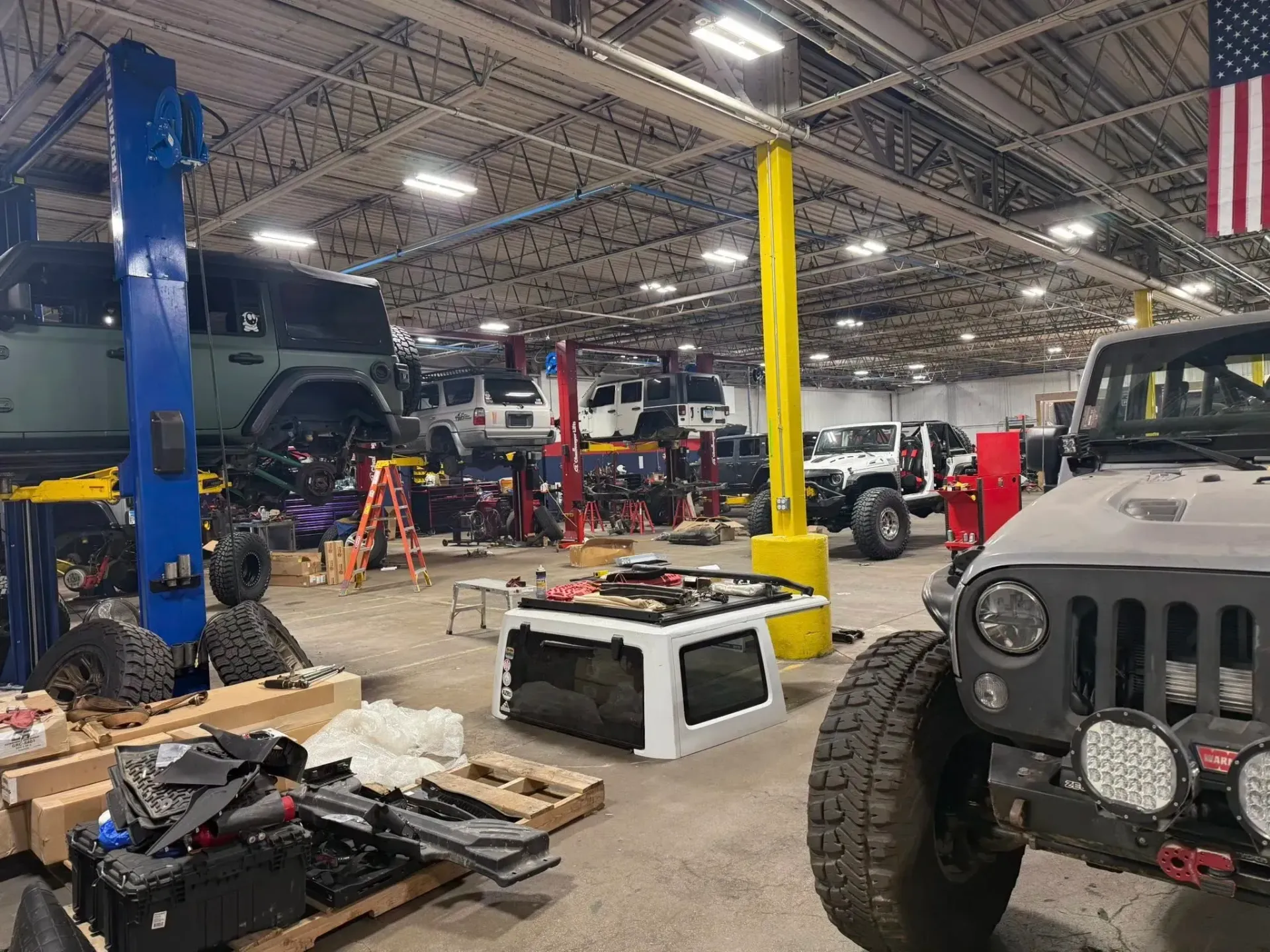Auto Repair Shop Interior with Several Jeeps on Lifts | Freedom Forged Auto Repair