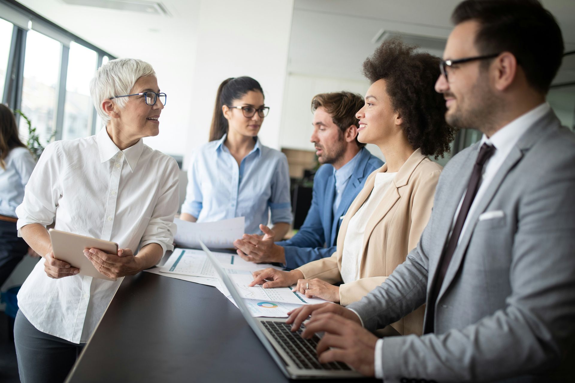 Business team in an office, working on a project. They are diverse and focused.