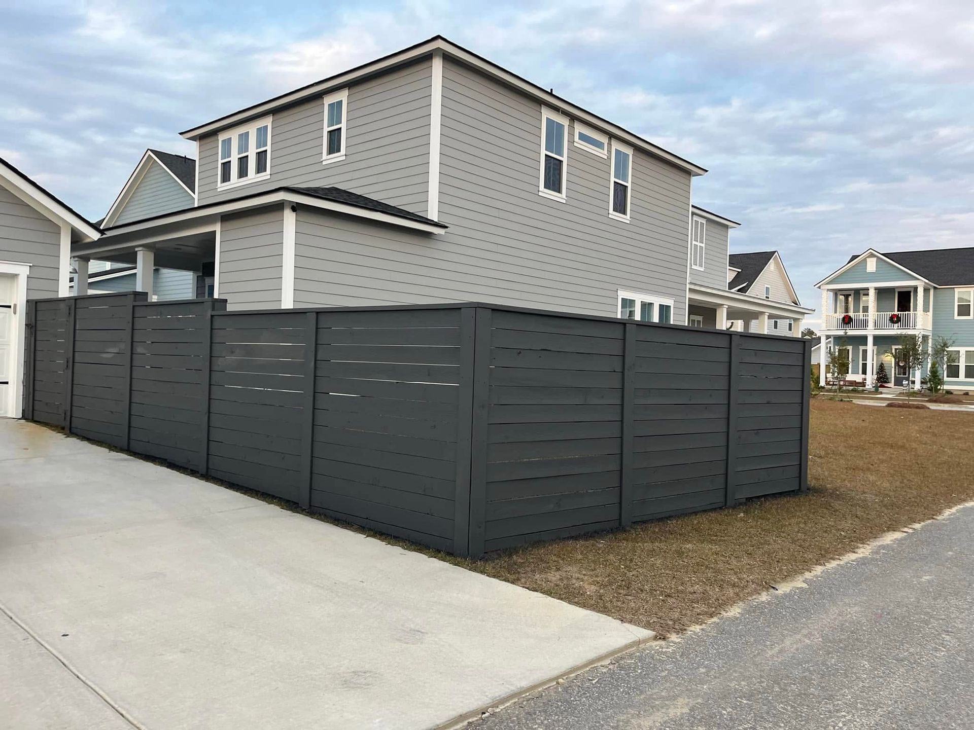 A house with a black fence in front of it.