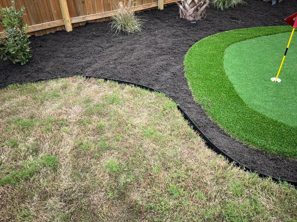 A person is playing golf on a green in a backyard.