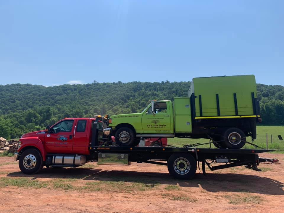 Green truck on red tow truck - Harrisburg, PA - Dingman’s Towing and Recovery LLC