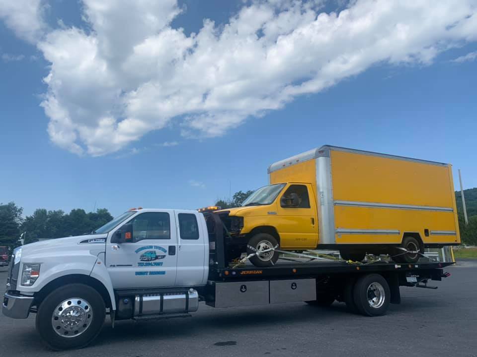 Yellow delivery truck on white truck - Harrisburg, PA - Dingman’s Towing and Recovery LLC