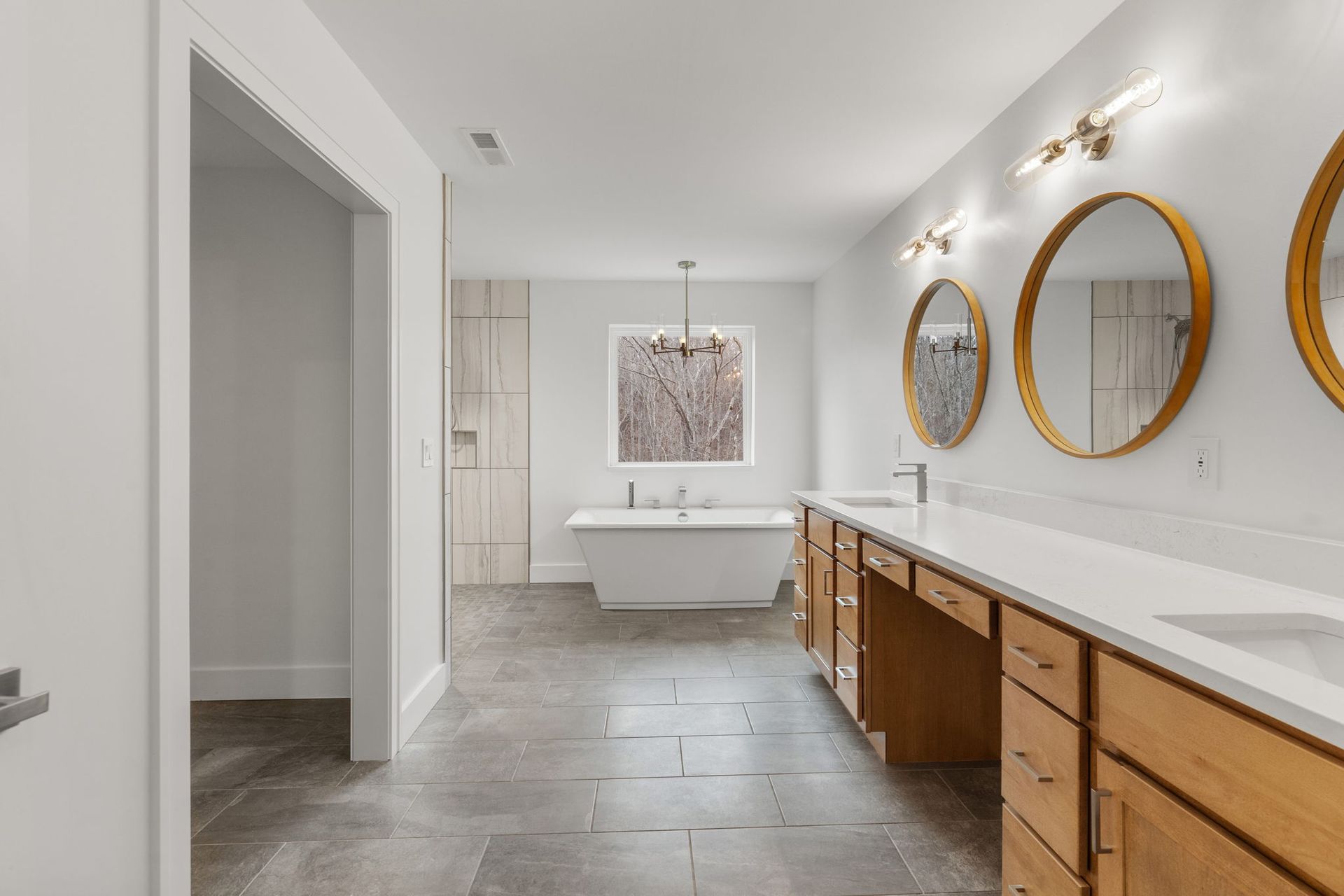 Spa-inspired bathroom with soaking tub, walk-in shower, and double vanity designed by a custom home builder in Chattanooga.