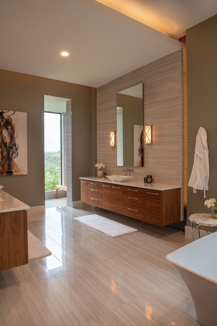 Modern bathroom with floating wood vanity, neutral tones, large window, and artwork.