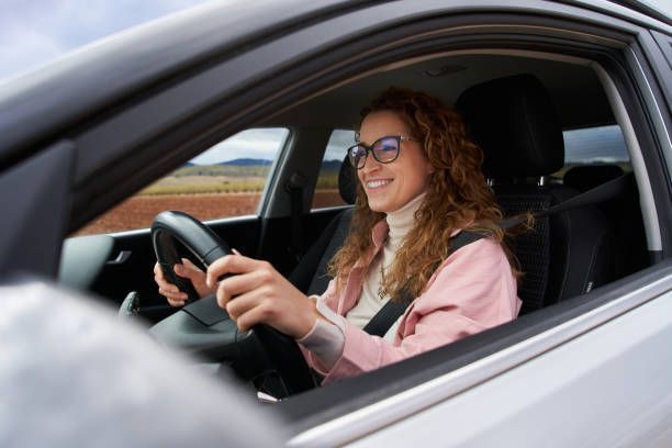 Woman inside her new car insured driving.