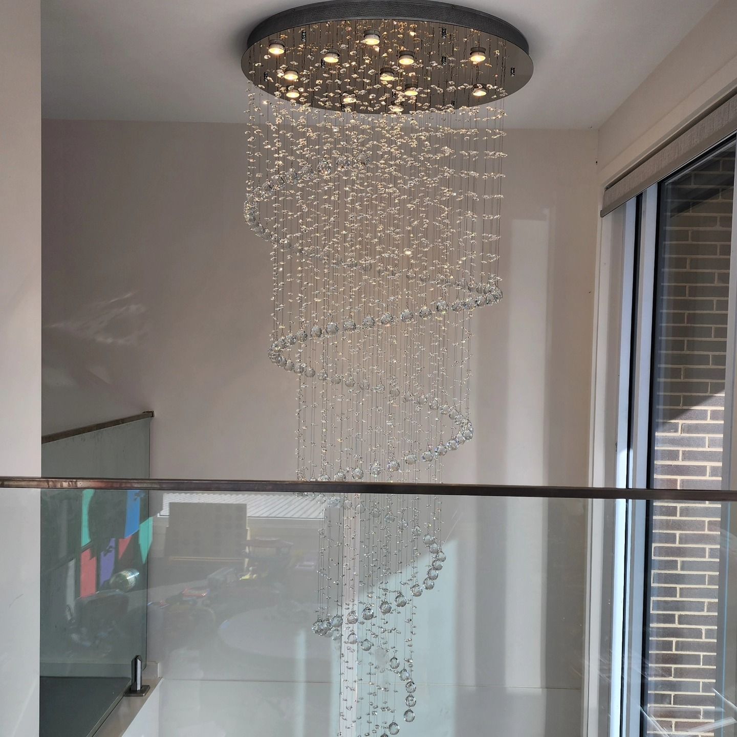 A Large Chandelier is Hanging From the Ceiling — Professional Electrical & Data Pty Ltd in Bonner, ACT
