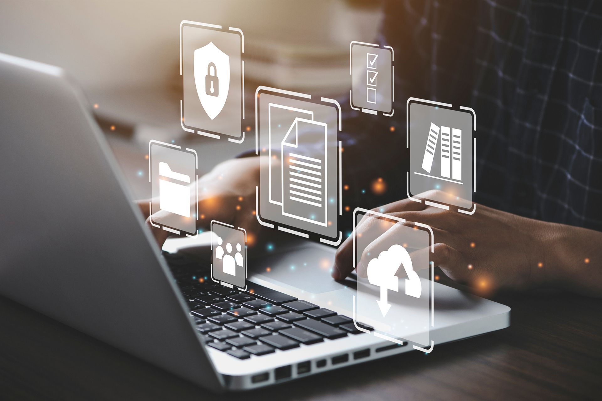 A person is typing on a laptop computer with a bunch of icons coming out of it