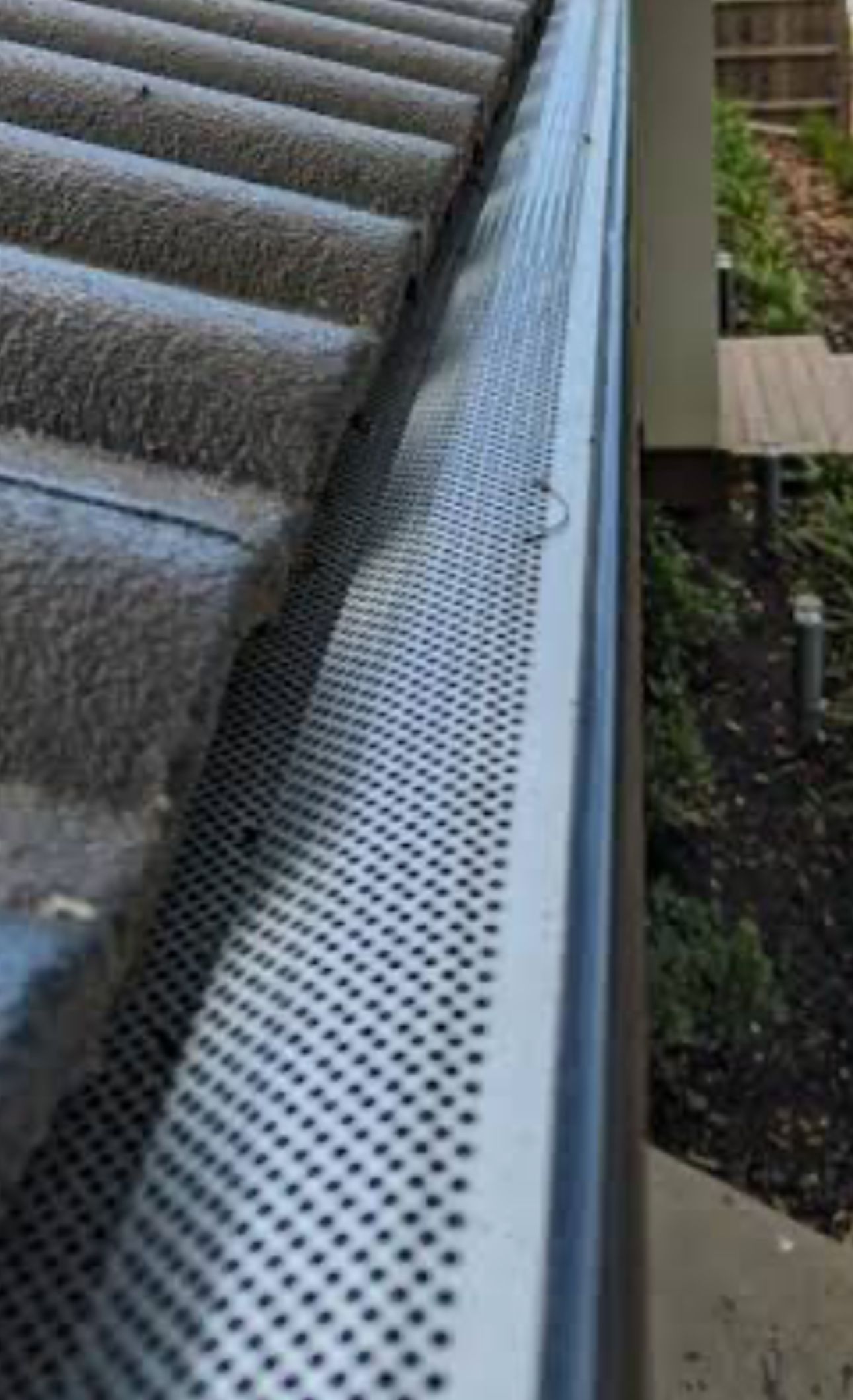 A Close Up of a Black Gutter on the Side of a House — CBR Maintenance In Curtin, ATC